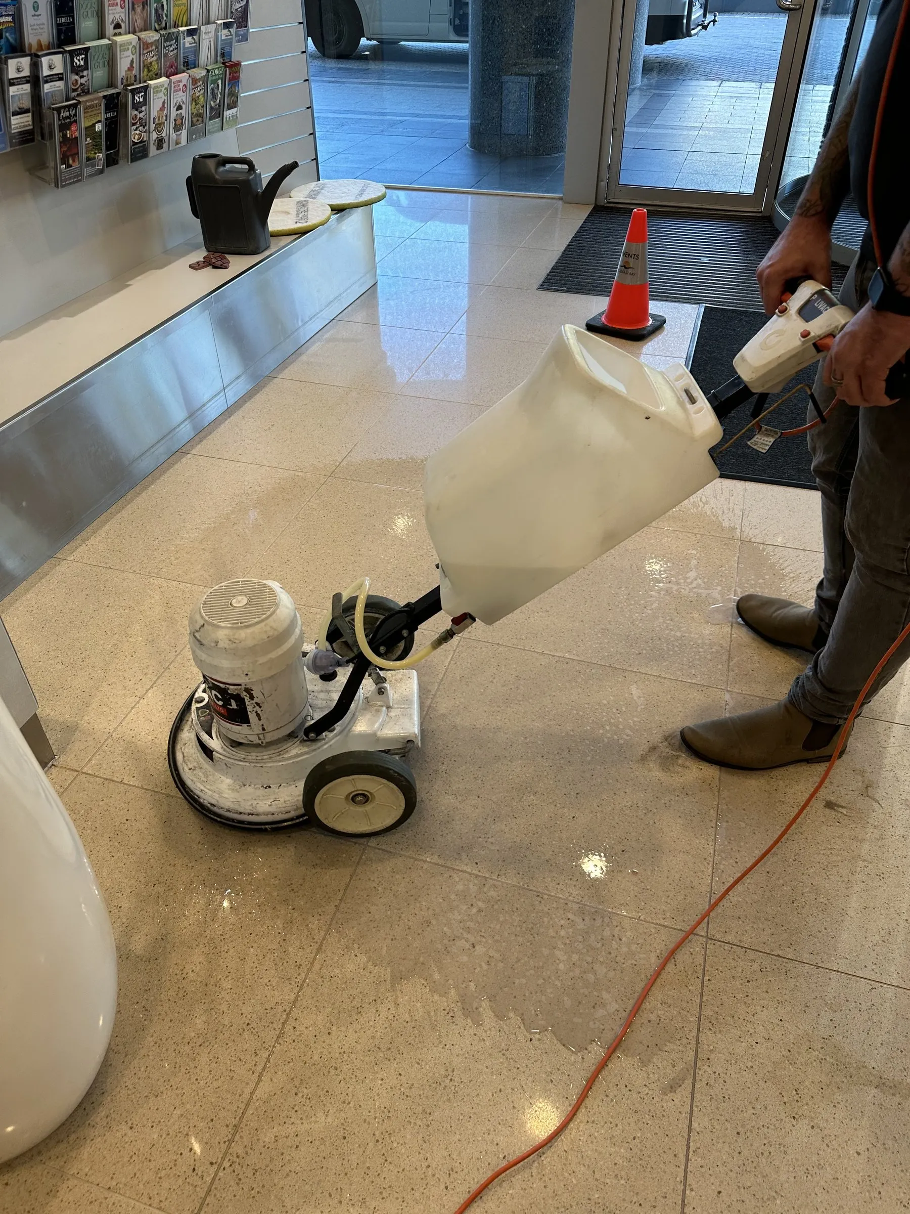 Rotary floor machine polishing a pale showroom floor